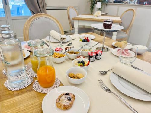 a table with breakfast foods and drinks on it at Villa Nonna Cicci Boutique Hotel - SPA in Cisterna dʼAsti