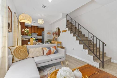 a living room with a couch and a staircase at modern design home near disneyland in Fullerton