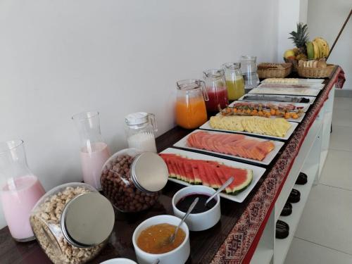 a buffet with many different types of food and drinks at Hostal Paqarina San Blas in Cusco
