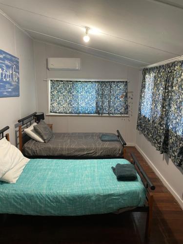 a room with two beds and two windows at Central on Shenton in Geraldton