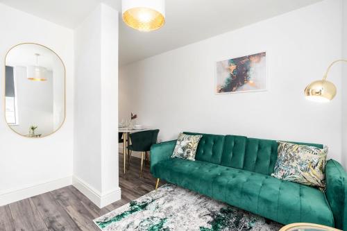 - un canapé vert dans le salon avec une table dans l'établissement Exclusive One Bedroom Apartment - City Centre - Free Wi-Fi Netflix, à Sheffield