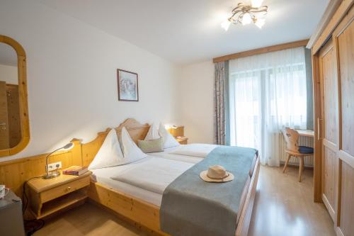 a bedroom with a large bed with a hat on it at Ferienhaus Helmuth Oberreiter in Flachau
