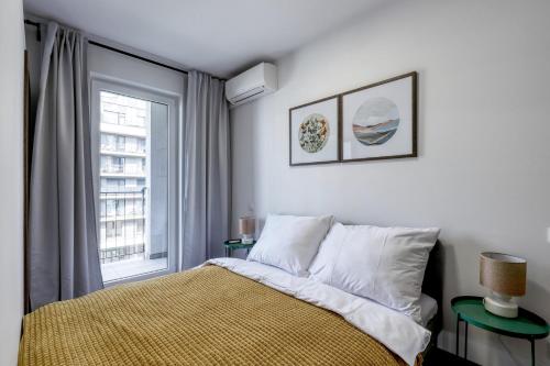 a bedroom with a bed and a window at STAR stylish flat in a modern neighborhood in Bratislava