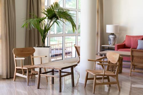 a living room with a table and chairs and a plant at Hotel Sa Punta - Adults Only fr13 in Begur