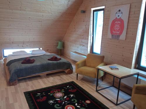 1 dormitorio con 1 cama y 1 silla en una habitación en Dom Pod Skałą, en Jeleniów