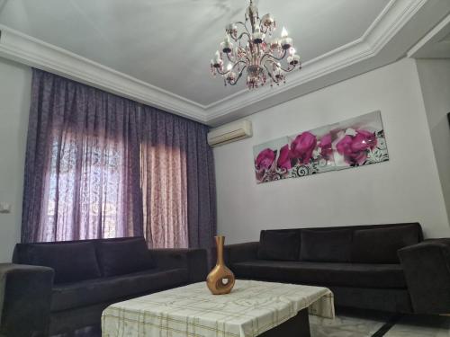 a living room with two couches and a table at Diar Tunis Carthage II in Ariana