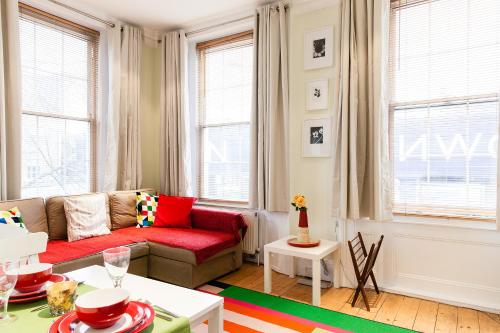 a living room with a couch and a table at Stunning Bright flat in London