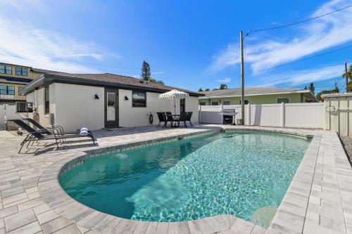 a swimming pool in front of a house at Madeira Beach House Retreat with Private Pool - The Perfect Getaway! in St. Pete Beach