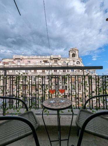 a table and chairs in front of a large building at Old Town Studio - Victoriei 2 in Bucharest