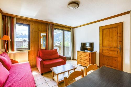 a living room with a couch and a table at Montenvers furnished flat in Chamonix