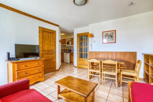 a living room with a table and a dining room at Montenvers furnished flat in Chamonix