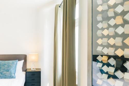 a bedroom with a bed and a wall with paper at Hotel & Restaurant Rose in Bietigheim-Bissingen