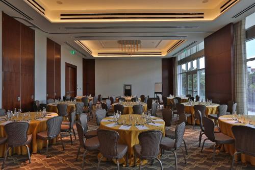a ballroom with tables and chairs in a room with windows at InterContinental Real Santo Domingo by IHG in Santo Domingo