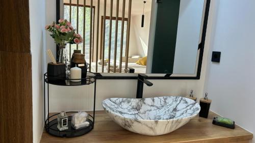 a bathroom with a large marble sink in front of a mirror at Hotel Blisku do gradot in Skopje