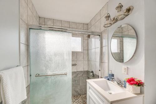 a bathroom with a shower and a sink and a mirror at South Central LA Home with Patio 11 Mi to Ocean! in Compton
