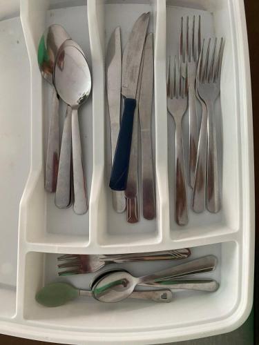 a drawer filled with silver utensils and forks and spoons at Monte Carmel in Ribeirão Preto