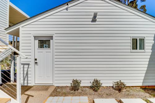 a white garage with a white door on a house at Waterfront Colonial Beach Studio with Boat Dock! in Colonial Beach