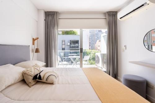 a bedroom with a large bed and a balcony at Charming apart in Palermo in Buenos Aires