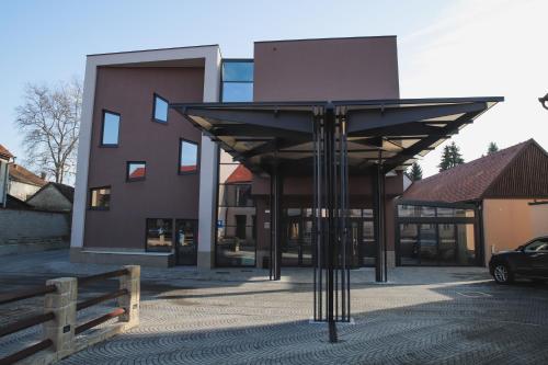 a building with awning in front of a building at Hotel Bernarda in Varaždinske Toplice