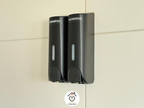 a set of two black notebooks sitting on a wall at Family M Apartments 21-22 in Sempach