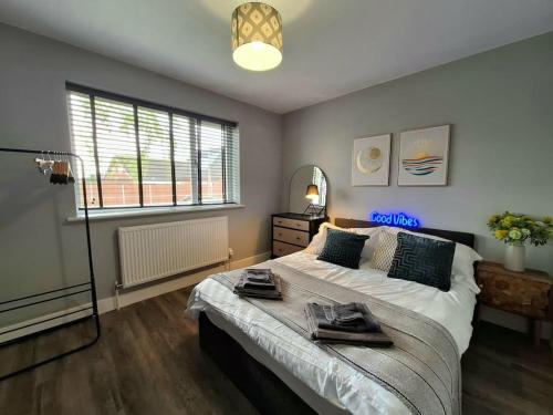 a bedroom with a large bed with towels on it at Unique & Pet Friendly Luxury Retreat With Hot Tub in Horsham Saint Faith
