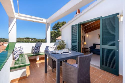 a patio with a table and chairs on a balcony at Tina apartment in Port d'Addaia
