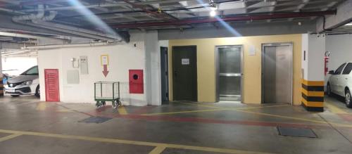 a garage with two doors and cars parked in it at Nallah ApartHotel in Natal