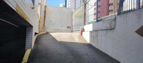 an empty alley in a city with a building at Nallah ApartHotel in Natal