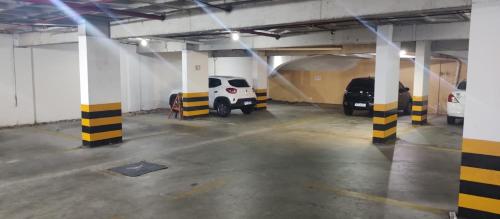a parking garage with two cars parked in it at Nallah ApartHotel in Natal