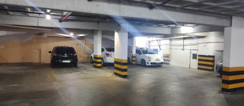 a parking garage with two cars parked in it at Nallah ApartHotel in Natal