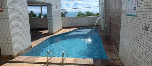 a swimming pool with a hose in a building at Nallah ApartHotel in Natal