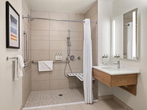 a bathroom with a sink and a shower at Staybridge Suites Minneapolis-Bloomington by IHG in Bloomington