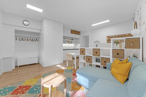 a living room with a blue couch and a table at Vilnius Old Town apartment in Vilnius