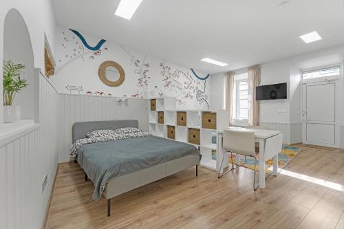 a bedroom with a bed and a desk at Vilnius Old Town apartment in Vilnius