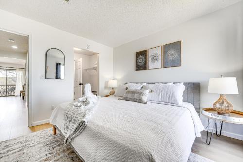 a white bedroom with a bed and a table at 5 Mi to Strip! Pointe Royale Condo w/ Indoor Pool in Branson