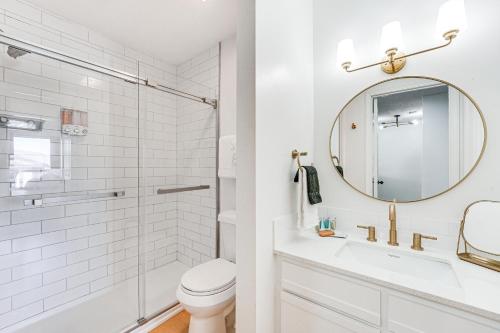 a white bathroom with a sink and a mirror at 5 Mi to Strip! Pointe Royale Condo w/ Indoor Pool in Branson