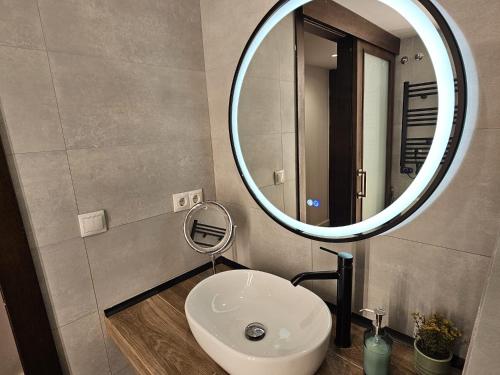 a bathroom with a white sink and a mirror at intercomerciofeja Experiencia de Lujo in Benalmádena