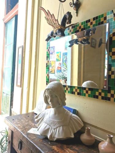 a statue of a woman sitting on a table at El Secreto Casa Art in Montevideo