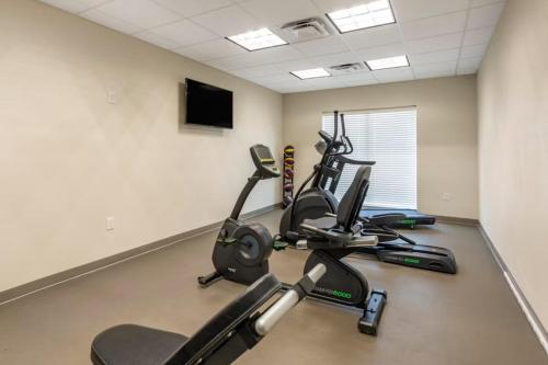 a gym with cardio machines and a flat screen tv at Garner Hotel Clarksville Northeast by IHG in Clarksville