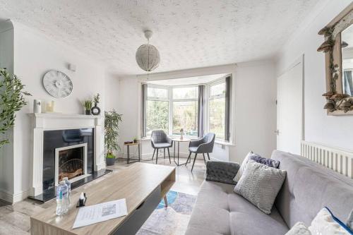 a living room with a couch and a fireplace at Detached House with Free Parking, Fast Wifi, Smart TV and Garden by Yoko Property in Coventry