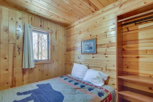 - une chambre avec un lit dans une cabane en rondins dans l'établissement Wooded Park Rapids Cabin Lake Access, Boat Slip!, à Arago