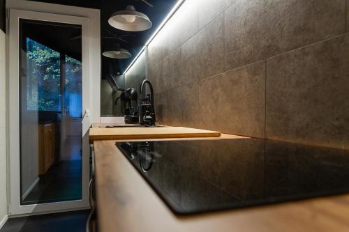 a kitchen with a sink and a mirror at AndBnB I Cerca de Grandvalira con Terraza + Parking gratis in Soldeu