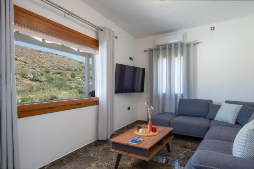 a living room with a couch and a table at Seacret House Sifnos in Faros