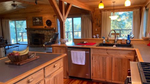 a kitchen with a sink and a stove top oven at Hideaway Ranch in Bonners Ferry