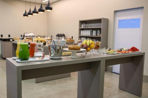 a table with food on it in a kitchen at Amazon Green Hotel in Lucas do Rio Verde