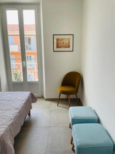 a bedroom with a bed and a chair and a window at Appartement port de Sanary in Sanary-sur-Mer