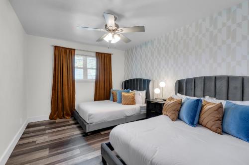 a bedroom with two beds and a ceiling fan at 10min to EXPO - Family-Friendly with Office & Playroom in Tulsa