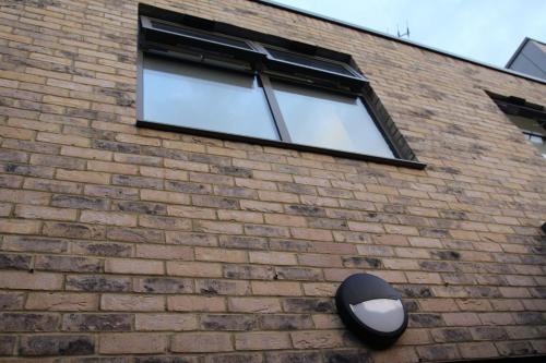 a window on the side of a brick building at Brand new Greenwich house-Heart of London-Great connections to Central London in London