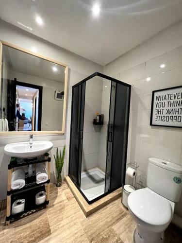 a bathroom with a toilet and a sink and a shower at Ocean view sunset apartment in the heart of Rabat in Rabat