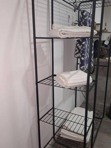 a black shelf with towels on it in a room at Casa Jungla Playa Avellanas in Río Sequito